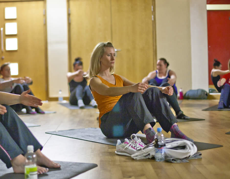 Group Taking Part In A Pilates Fitness Class